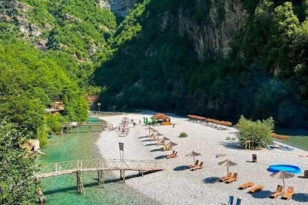 Komani Lake boat tour through turquoise water and steep canyon cliffs in Albania. Visit Shala River