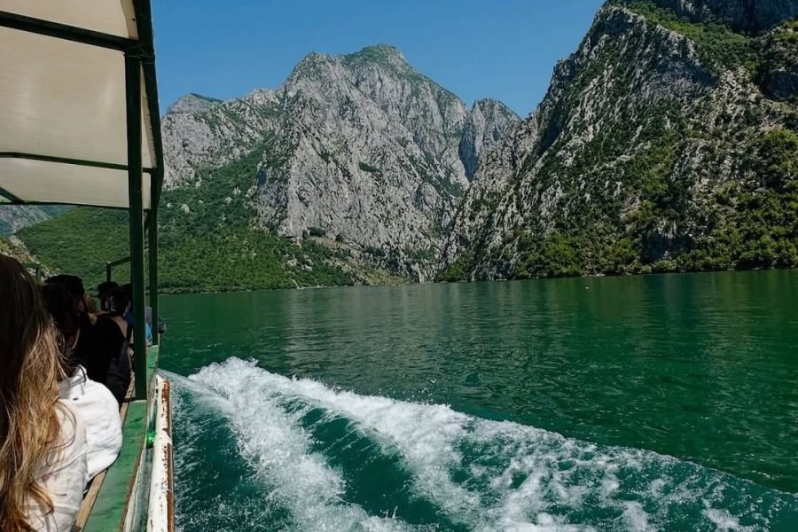 Scenic Komani Lake boat tour in northern Albania with mountain views
